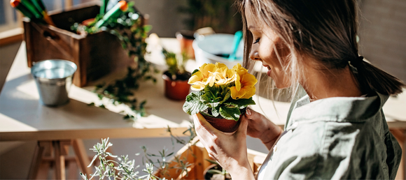 A woman holding a flower pot.